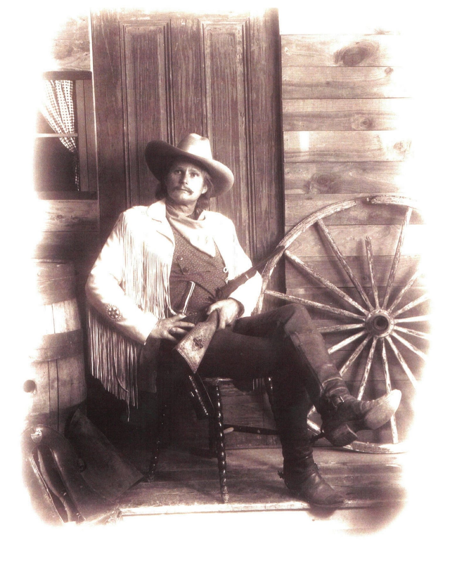 Jim Stuckenberg seated in Western attire